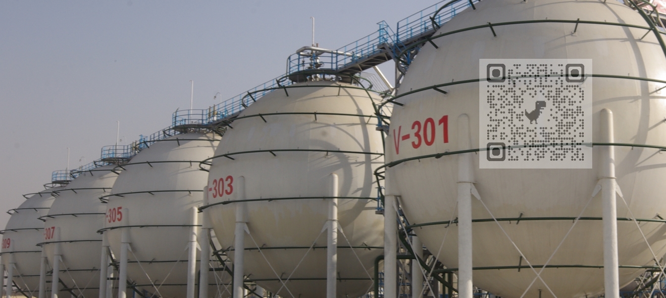 A row of large industrial storage tanks at a manufacturing facility, designated for n-Hexane, n-Heptane, and Isohexane.