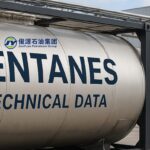 A clean industrial scene showing stainless steel ISO tanks and drums used for high-purity Pentane storage and transportation, symbolizing quality and reliability in blowing agent solutions.