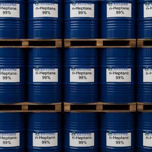 Stacked blue metal drums labeled n-Heptane, 99% on wooden pallets in warehouse